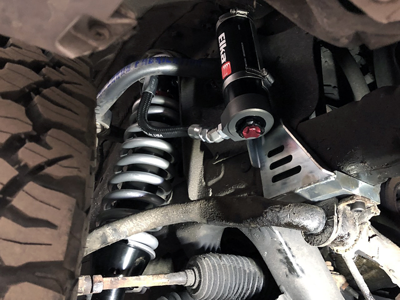 Remote reservoir coilovers installed on a Tacoma